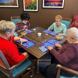A group of people playing bingo together at a table.