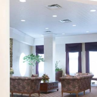 A well-lit lobby area with comfortable seating and decorative plants.