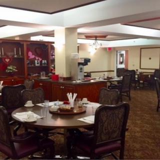 A cozy dining room with elegantly set tables and comfortable chairs.