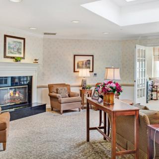 A cozy living room with a fireplace and elegant furniture.