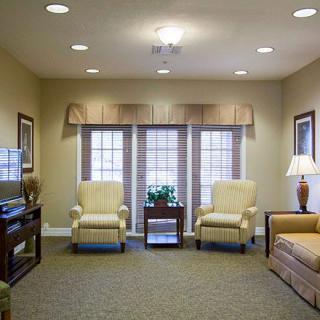 A cozy living room with comfortable seating and warm lighting.
