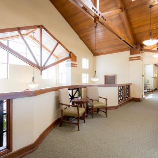 A well-lit lobby area featuring wooden accents and comfortable seating.