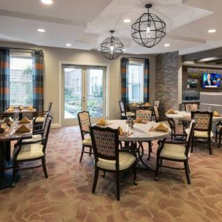 A modern dining room with elegant furnishings and ample natural light.