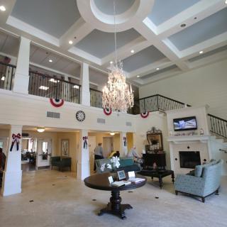 A luxurious and spacious living room featuring elegant interior design with a grand chandelier.
