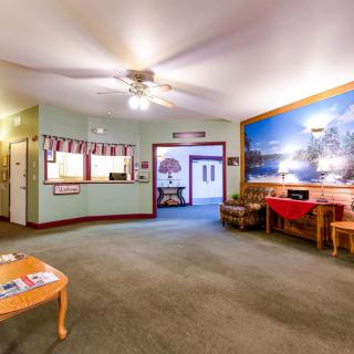 A cozy lobby featuring a reception desk, seating area, and decorative artwork on the wall.