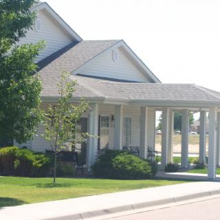 A suburban residential house with a well-maintained front yard and a covered porch.