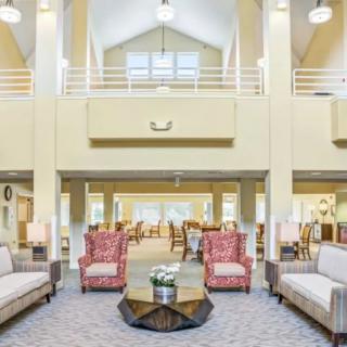 A spacious and bright living room with comfortable seating and elegant decor.