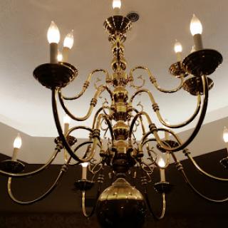 An ornate chandelier illuminating a space with a warm glow.