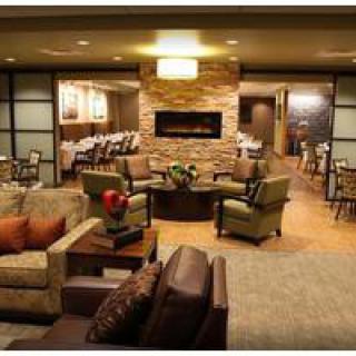 A cozy lounge area with comfortable seating and a fireplace.