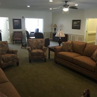 A cozy living room with comfortable seating and warm lighting.