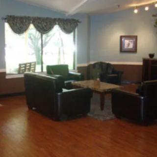 A cozy living room with comfortable seating and a large window.