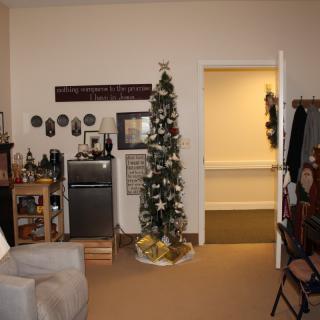 A cozy living room with a Christmas tree and festive decorations.