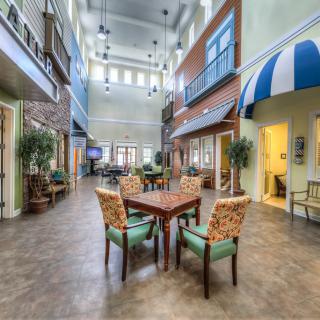 A luxurious lobby with seating area, featuring elegant decor and ample natural light.
