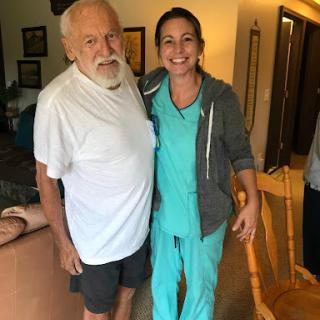 A joyful moment between a caregiver and an elderly man.