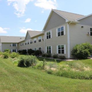 A suburban residential building with a landscaped yard.