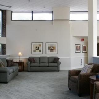 A modern lobby area with sofas and armchairs arranged in a spacious, well-lit setting.
