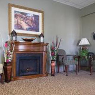 A cozy living room setup featuring a classic fireplace and elegant decor.