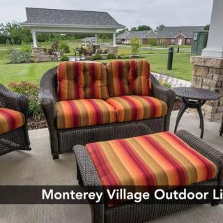 Outdoor seating area with striped cushions at Monterey Village.