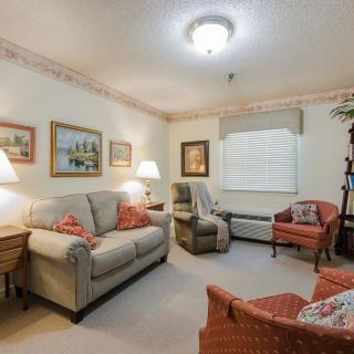 A cozy living room with comfortable seating and warm lighting.