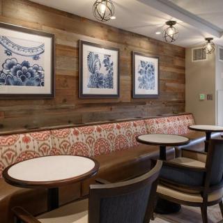 Cozy cafe interior with wooden paneling and artistic decor.