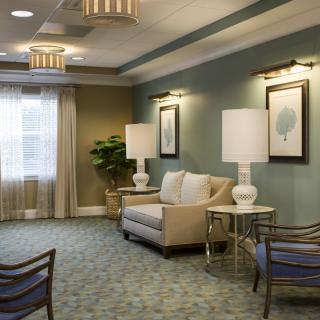 A cozy and elegantly decorated living room with comfortable seating and soft lighting.