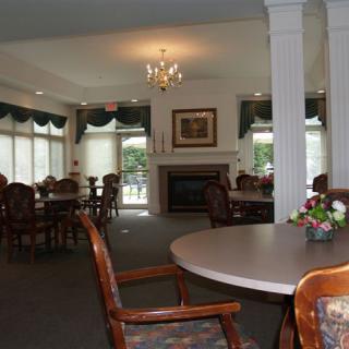 A spacious dining area with elegant furniture and a fireplace.