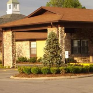 A suburban building with landscaped surroundings and a sloped roof.