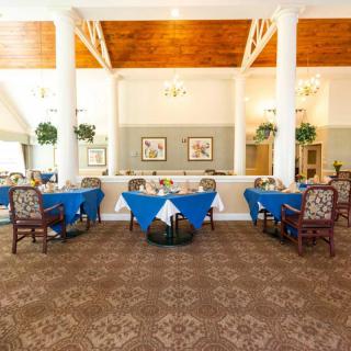 An elegant dining area with blue tablecloths and stylish decor.