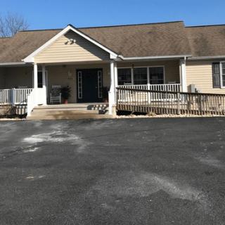 A single-story residential house with a porch and driveway.
