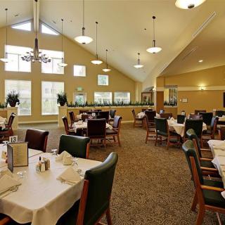 A spacious dining area with elegantly set tables and large windows.