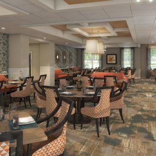A cozy dining area with stylish interior design, featuring patterned chairs and elegant lighting.