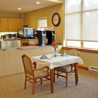 A cozy dining area with a neatly set table and comfortable chairs, perfect for a meal.