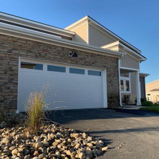 A modern residential house featuring a stone facade and a two-car garage.