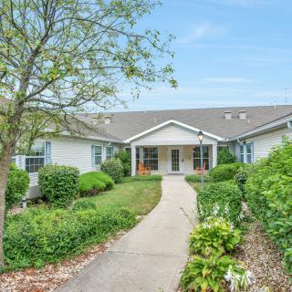 A charming house with a garden and a pathway leading to the entrance.
