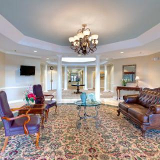 A luxurious lobby with elegant furnishings and a grand chandelier.