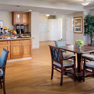 A cozy kitchen and dining area with wooden flooring and elegant furniture.