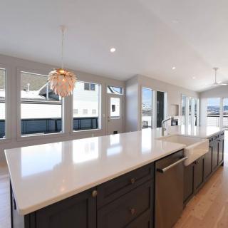 A spacious, modern kitchen with a large island and ample natural lighting.
