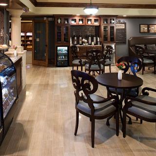 An elegant cafe interior with stylish furniture and warm lighting.