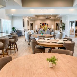 A modern dining room with neatly arranged tables and chairs.