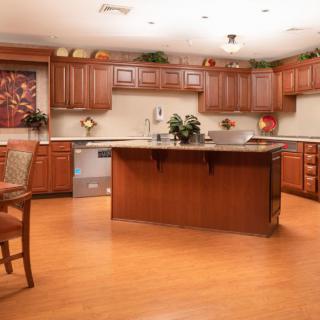 Spacious kitchen with wooden cabinets and a central island.