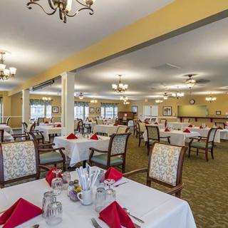 A spacious dining room with neatly arranged tables and elegant lighting.