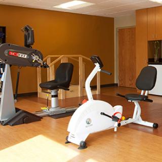 A fitness area featuring exercise bikes and other gym equipment.
