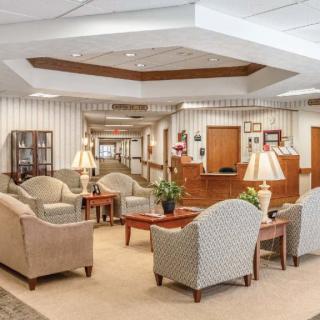 A spacious lobby area with comfortable seating and a reception desk.