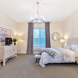 A modern and cozy bedroom with elegant decor and soft lighting.
