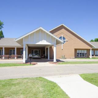 A modern church building with a welcoming entrance on a sunny day.