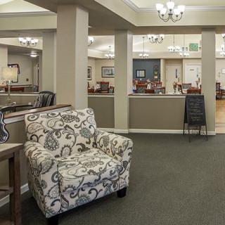 A cozy lounge area with patterned armchair and elegant decor.