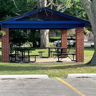 A sheltered picnic area with tables, perfect for outdoor gatherings.