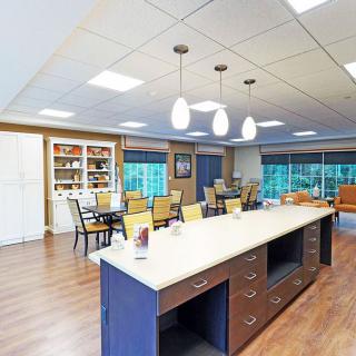 A modern and spacious kitchen and dining area with an island counter and pendant lighting.