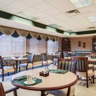 A well-lit, cozy dining area with neatly arranged tables and chairs.