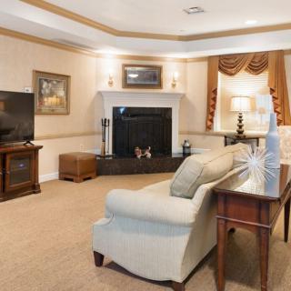A cozy living room featuring a fireplace, sofa, and television.